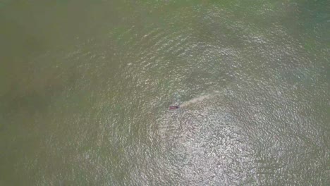 Victoria-Island-Lagos,-Nigeria---20-November-2022:-Drone-view-of-a-fisherman-on-a-fishing-boat-on-the-coastline-of-Lagos