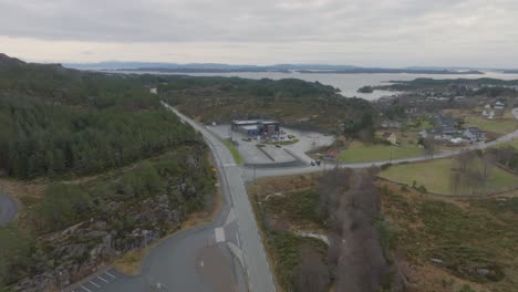 Grocery-store-SPAR-in-Steinsland-at-Sotra-island-Norway---Aerial-with-people-shopping-and-fjord-in-background