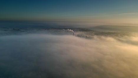 Aerial-Drone-scene-above-the-Urban-townscape-area-shrouded-In-thick-morning-mist