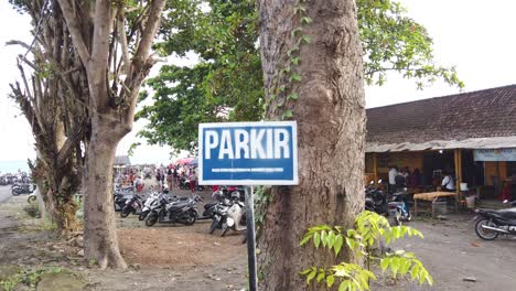 Parking-Space-in-Bali,-Indonesia,-Southeast-Asia,-Parkir,-Scooters,-Motorcycles-near-Local-Food-Stores-in-Purnama-Beach,-Balinese-Black-Sand-Beach