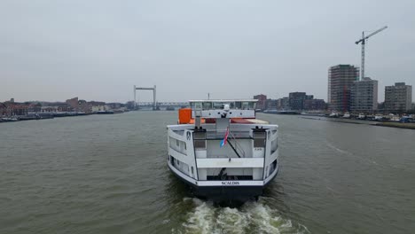 Stern-View-Of-Scaldis-Container-Ship-Travelling-Along-Oude-Maas-On-Overcast-Day-In-Dordrecht