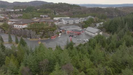 Cirkle-K-gas-and-energy-station-in-Skogsvag-Oygarden-Norway---Wide-angle-aerial-overview-with-forest-in-foreground