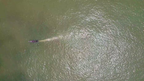 Victoria-Island-Lagos,-Nigeria---20-November-2022:-Drone-view-of-a-fisherman-on-a-fishing-boat-on-the-coastline-of-Lagos