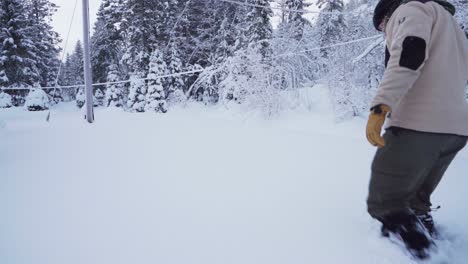 Man-Walking-In-Deep-Snow-In-Indre-Fosen,-Norway---wide
