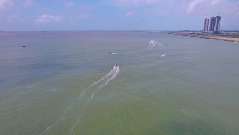 Victoria-Island-Lagos,-Nigeria---20-November-2022:-Drone-view-of-a-fisherman-on-a-fishing-boat-on-the-coastline-of-Lagos