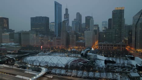 Aerial-view-over-the-Jay-Pritzker-Pavilion,-foggy,-winter-evening-in-Chicago,-USA