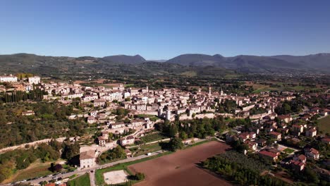 Aerial-view-of-ancient-town-Spello-in-a-green-landscape-on-a-sunny-day,-Italy