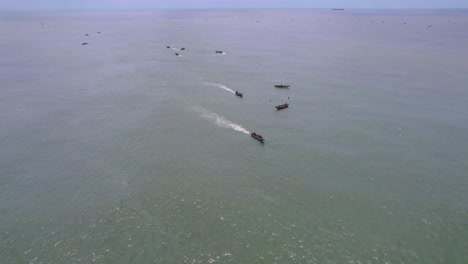 Victoria-Island-Lagos,-Nigeria---20-November-2022:-Drone-view-of-a-fisherman-on-a-fishing-boat-on-the-coastline-of-Lagos