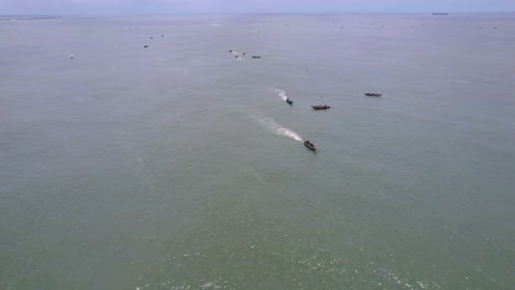 Victoria-Island-Lagos,-Nigeria---20-November-2022:-Drone-view-of-a-fisherman-on-a-fishing-boat-on-the-coastline-of-Lagos