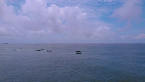 Victoria-Island-Lagos,-Nigeria---20-November-2022:-Drone-view-of-a-fisherman-on-a-fishing-boat-on-the-coastline-of-Lagos