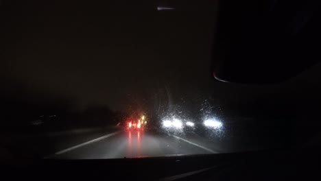 Timelapse-shot-of-a-car's-nighttime-drive-on-a-road-with-lights-and-other-vehicles