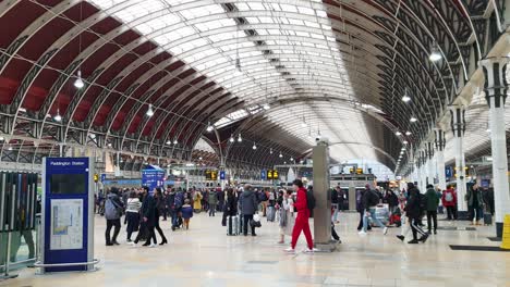 Busy-New-Years-Eve-with-people-wandering-around-the-train-terminal-at-London-Paddington-Railway-and-Underground-Station-during-Winter-festive-season