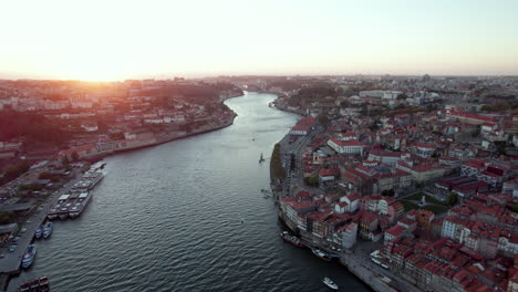 Aerial-reveal-pull-back-shot-over-river-in-Porto-Portugal