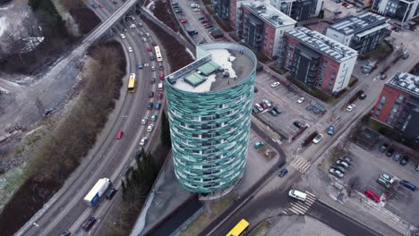 Tall-cylindrical-shaped-apartment-building-in-urban-environment