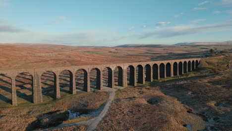 Railway-bridge-viaduct-full-reveal-at-sunset-in-winter-with-moorland