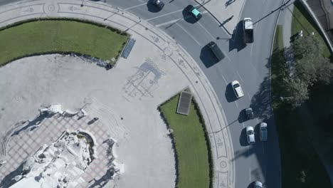 drone-flying-over-the-roundabout-in-marques-de-pombal-with-some-cars-going-to-work-in-a-sunny-day-at-winter