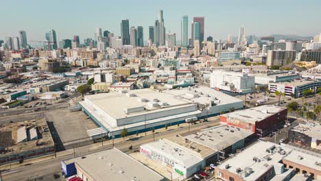 Breathtaking-drone-time-lapse-capturing-the-vibrant-cityscape-of-Los-Angeles-with-towering-buildings-and-bustling-streets-on-a-bright-sunny-day