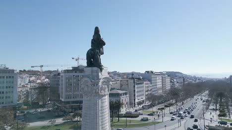 Aerial,-orbit,-drone-shot,-towards-Marquês-de-Pombal-statue-after-quarantine-time-with-first-cars-driving-in-Lisbon-city-streets-and-liberty-avenue-in-background,-sunny-day,-in-Lisbon,-Portugal