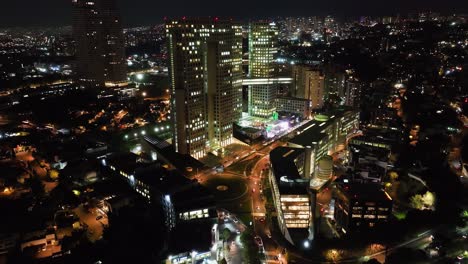 Aerial-view-of-traffic-in-front-of-the-Arcos-Bosques-de-las-Lomas,-night-in-Mexico-city