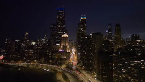 Aerial-view-overlooking-traffic-on-the-Michigan-Ave-and-the-Lake-Shore-Dr,-night-in-Streeterville,-Chicago,-USA