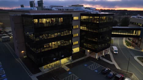 Aerial-orbiting-shot-of-office-building-at-night