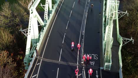 Charity-Santa-dash-fun-run-over-Runcorn-Silver-Jubilee-bridge-Aerial-view-top-down-zoom-in