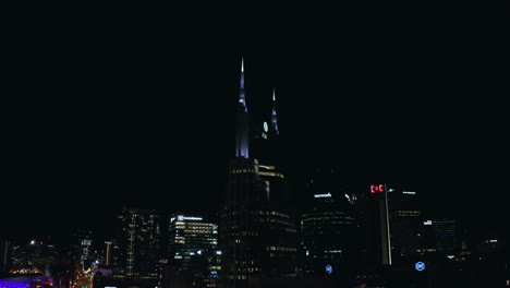 Aerial-orbiting-ATT-high-rise-building-in-downtown-Nashville-TN-at-night,-4K