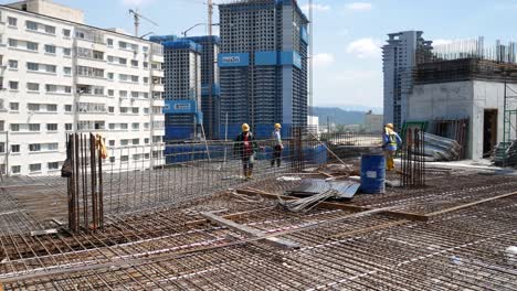 Construction-workers-fabricating-steel-reinforcement-bars-at-the-construction-site