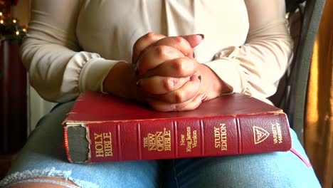 African-American-woman-praying-over-old-family-bible