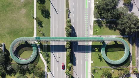 An-aerial-view-directly-over-a-pedestrian-walkway-which-crosses-a-six-lane-highway-on-a-sunny-day-in-Florida