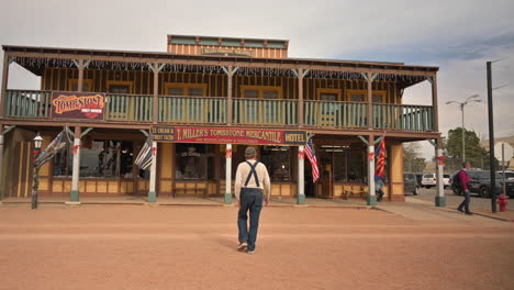 Male-tourist-crosses-street-in-historic-district-of-Tombstone-Arizona