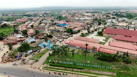The-Redeemed-Christian-Church-of-God-and-the-city-of-Mowe-Town-in-Ogun-State,-Nigeria---aerial-view