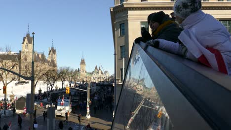 residents-watch-trucks-and-protesters-block-the-intersection-of-Streets-during-the-Anti-vaccine-convoy-protests-titled-"Freedom-convoy"-in-Ottawa,-Ontario,-Canada-on-January-30st-2022