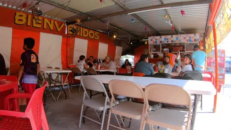 Tourist-enjoying-a-small-outdoor-restaurant-on-a-sunny-day