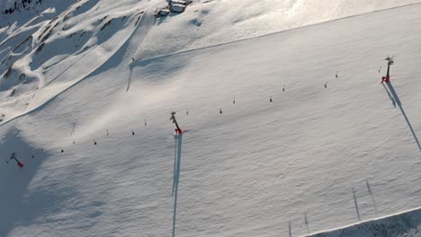 Dolly-forward-pan-down-drone-shot-over-high-alpine-ski-slope