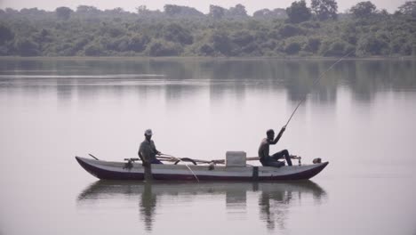 Wide-shot-of-poor-Sri-Lankan-fishermen-at-work-on-beautiful-lake-trying-to-catch-fish