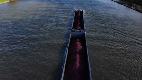 Aerial-Over-Sjouwer-Cargo-Carrying-Materials-Along-Oude-Maas-As-It-Passes-Underneath