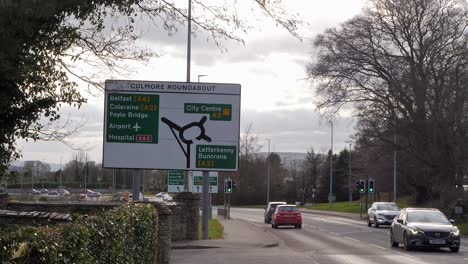 Derry-Londonderry-City,-Cars-pass-on-the-main-A2-Culmore-Road-towards-Culmore-Road-Roundabout-near-Foyle-Hospice-looking-toward-the-Foyle-Bridge