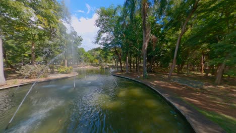 Aerial-drone-flight-over-idyllic-river-inside-Parque-Mirador-Sur-Park-in-Santo-Domingo,Dominican-Republic