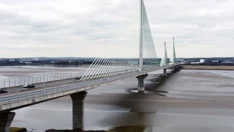 Mersey-gateway-landmark-aerial-view-above-toll-suspension-bridge-river-crossing-low-pull-back-shot