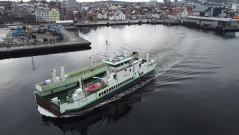 Ferry-Rygerbuen-sailing-from-Stavanger-to-Vassoy-in-Norway---Aerial-passing-in-front-of-ship-with-stavanger-city-in-background
