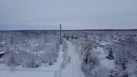 Snow-covered-forest-with-train-going-in-the-distance