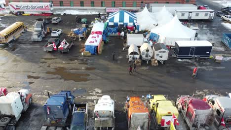 Trucks-by-side-of-road-at-Freedom-Convoy-in-Ottawa,-Canada,-aerial-pan