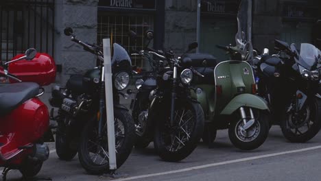 Motorcycles-parked-on-the-side-of-the-road-in-urban-city-panning-right