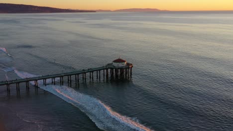 Waves-And-Manhattan-Beach-Pier-At-Sunset-In-California---aerial-static