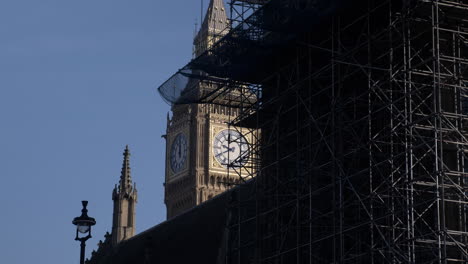 An-obscured-view-of-the-iconic-landmark-Big-Ben,-the-scaffolding-in-the-foreground-being-removed-after-the-completion-of-the-extensive-restoration-project-of-the-spectacular-clock-tower,-London,-UK