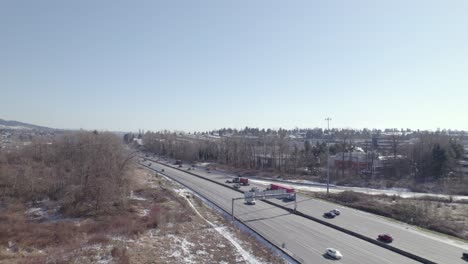 Drone-fly-above-Vancouver-suburban-area-with-car-truck-traffic-driving-on-main-highway-during-sunny-day