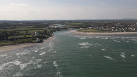 Drone-shot-of-a-small-seaside-town-in-Ireland-on-a-sunny-day