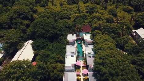 Breathtaking-aerial-flight-slowly-sinking-down-drone-shot-of-a-guy-in-a-pool
of-a-luxury-resort-hotel-on-a-scenic-tropical-dream-beach-island-Gili-Trawangan-Lombok