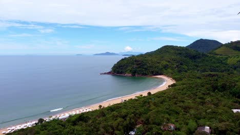Aerial-flying-over-forest-and-beach-at-district-of-Ubatuba-on-sunny-day,-Brazil